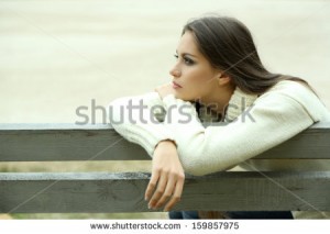 stock-photo-young-lonely-woman-on-bench-in-park-159857975