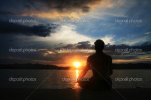 foreign man practicing Tai Chi on a beach.