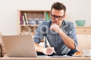 stock-photo-32837114-portrait-of-focus-man-working-at-home