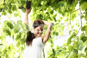 stock-photo-15146268-relaxed-woman-enjoying-the-nature-in-green-forest