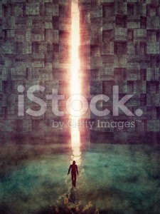stock-photo-48102524-man-walking-against-mysterious-light-behind-the-techno-stone-wall
